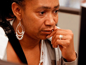 In this July 2, 2010 photo, Mischelle Mitchell looks online for job listings at the at the Oakland Career Center in Oakland, Calif. (AP Photo/Ben Margot)