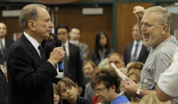 Senator Arlen Specter listened to a critic of the healthcare proposal yesterday at a forum in Lebanon, Pa. One shouting participant left the room after security guards approached him. (Bradley C Bower/Associated Press)