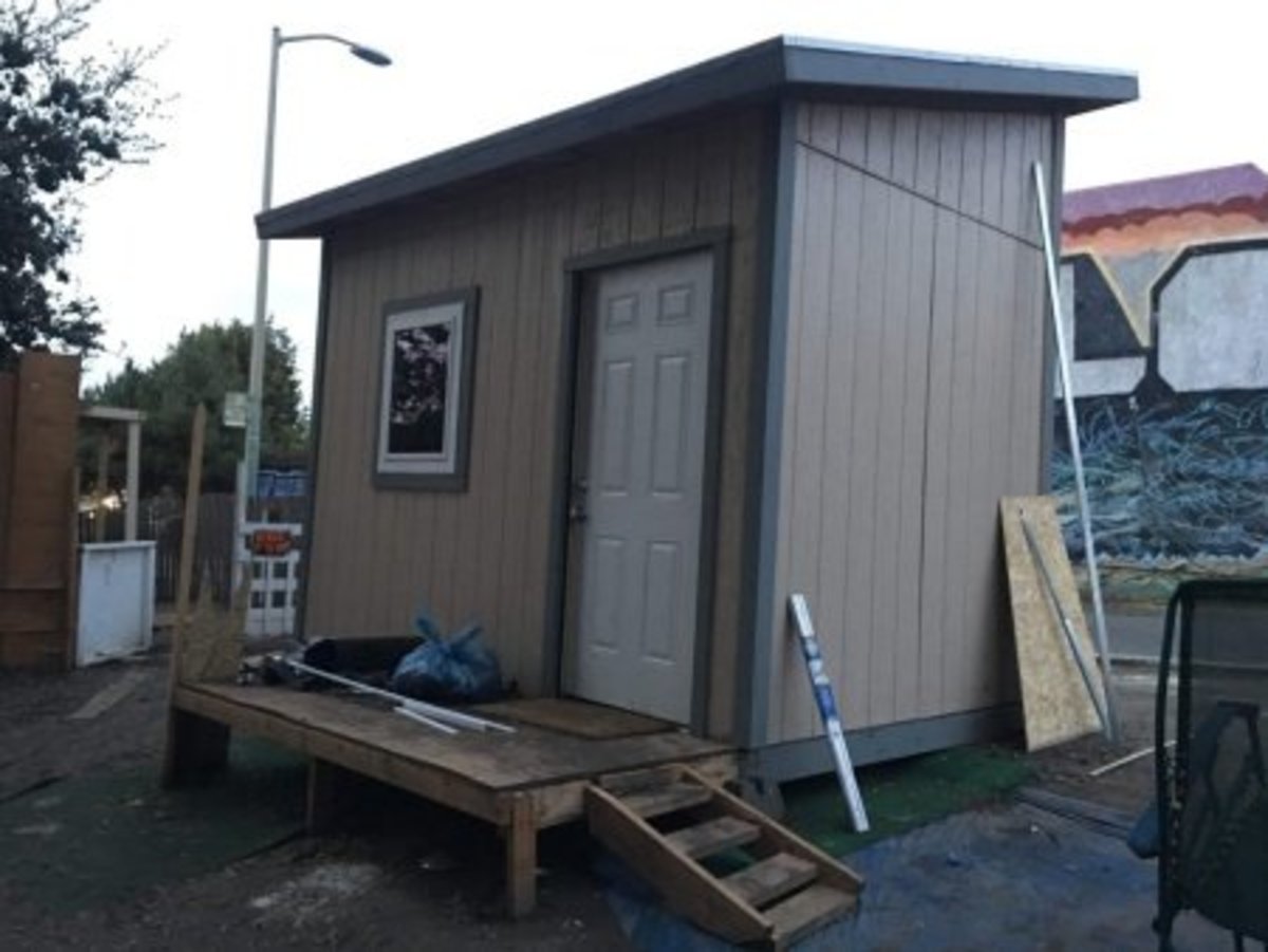 A tiny home built by The Village stands in an encampment in East Oakland. (Ariel Boone)
