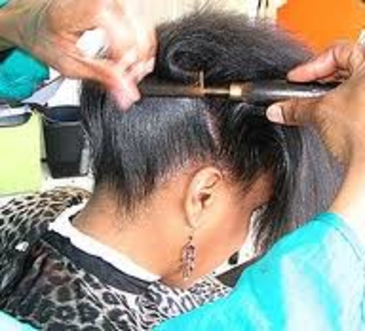  Hair being straightened with a "hot comb"