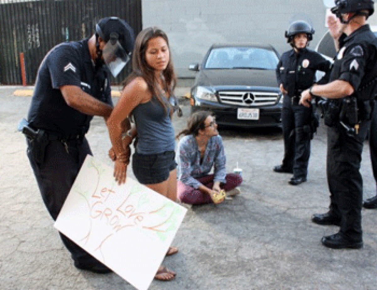 Christina Funck is arrested after refusing to sign a citation for jaywalking that she allegedly committed while participating in an anti-war march. Funck demanded to see proof of her jaywalking before she signed her ticket. (Dan Bluemel / LA Activist)