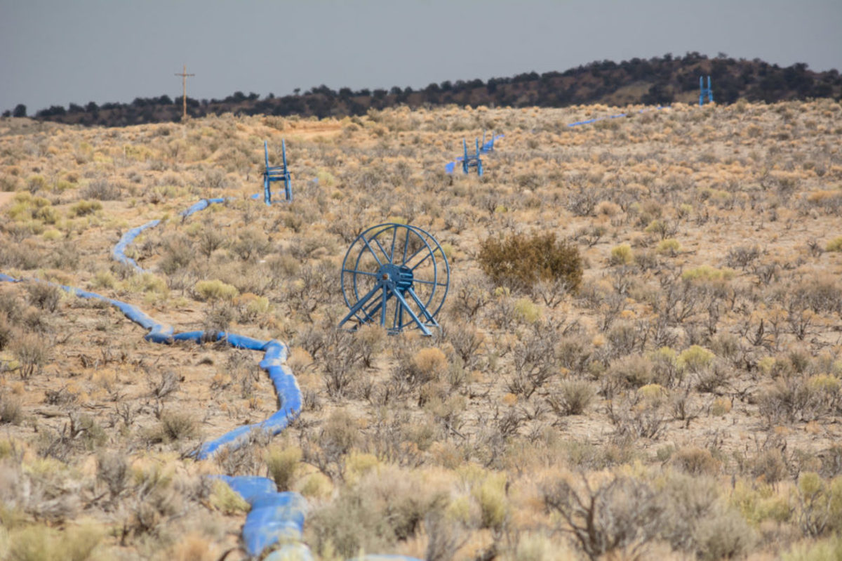 A fracking water hose runs through the desert an connects with a fracking operation on Navajo trust land north of Chaco Culture National Park. ©2021/Jerry Redfern