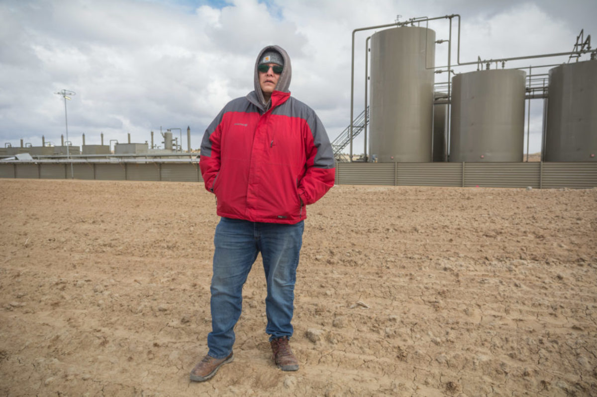 Mario Atencio stands in front of the wellsite that leaked fracking slurring into a wash near his grandmother's home in 2019. ©2021/Jerry Redfern