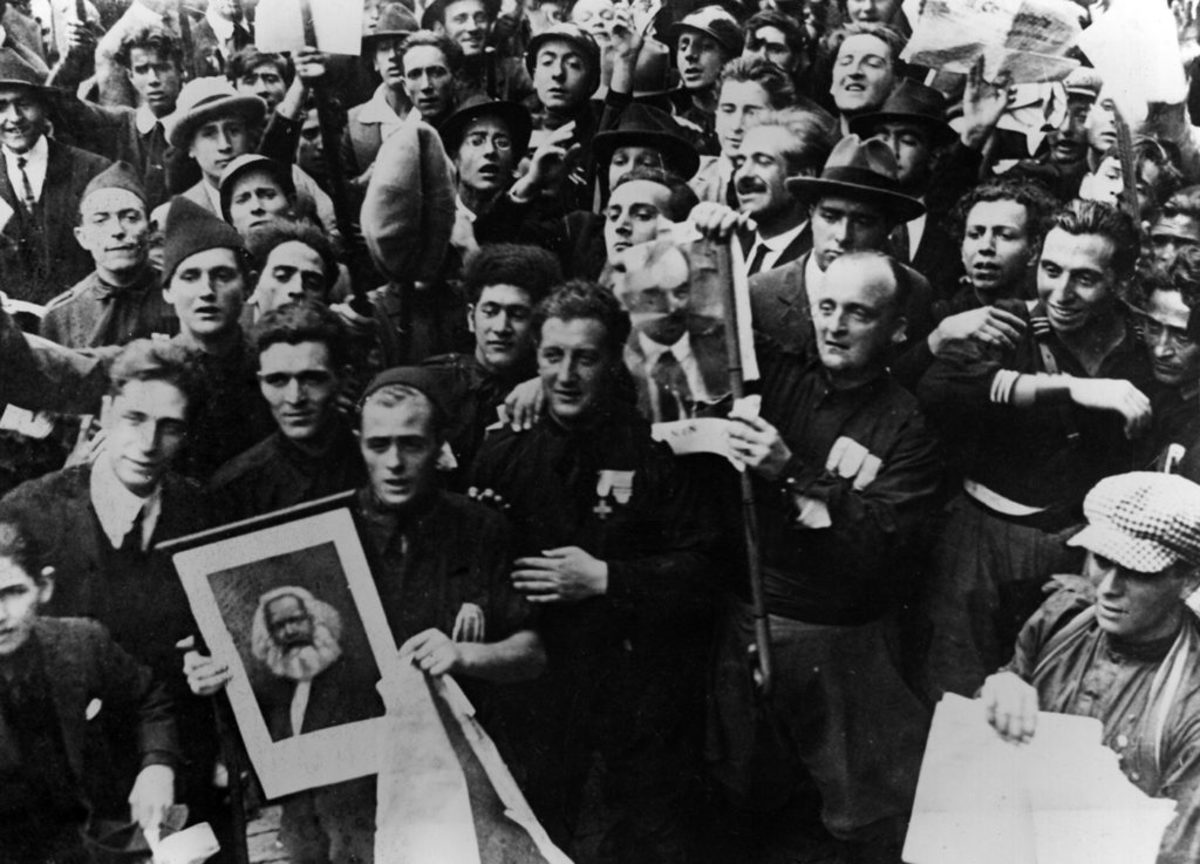 Blackshirts, supporters of Benito Mussolini who founded the National Fascist Party, are about to set fire to portraits of Karl Marx and Vladimir Lenin in Italy in May 1921. Photo by Mondadori/Getty Images.