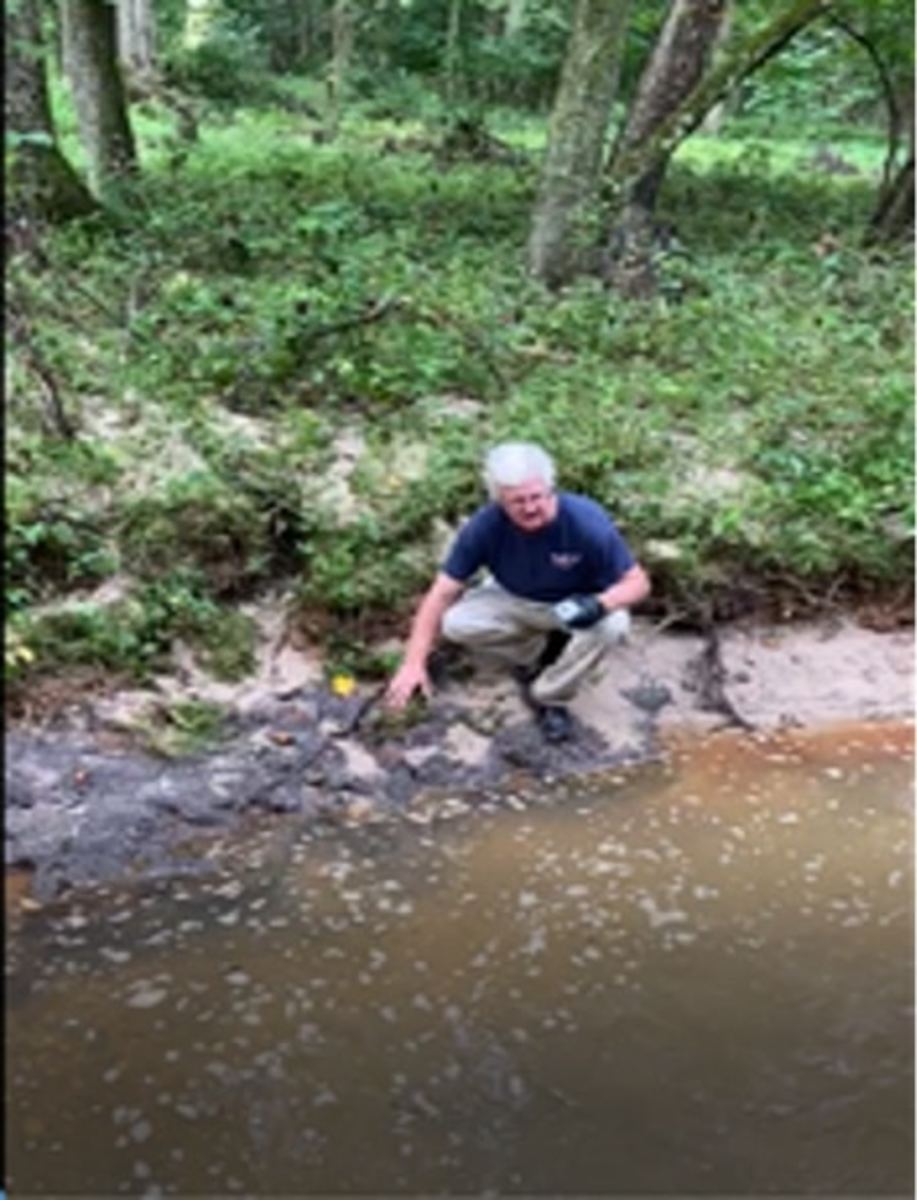 The author is shown on the banks of Piscataway Creek on August 12, 2020, about 1,000 feet from the base’s boundary. The creek was covered with foam.