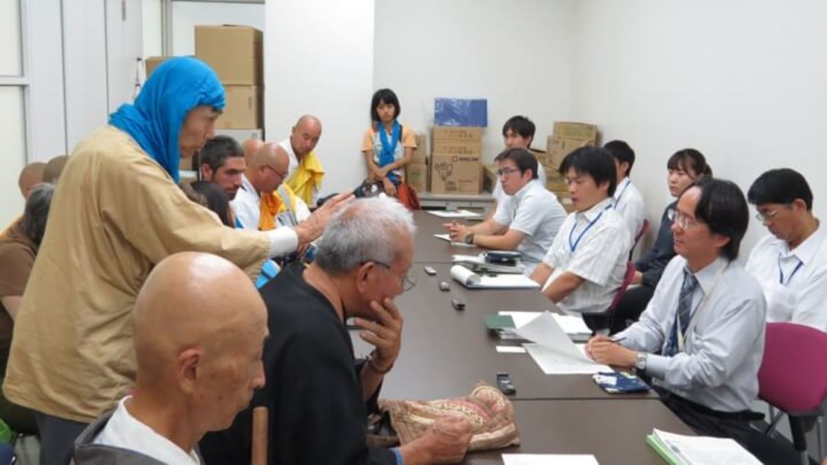 The kind monk (left, standing) and Yuichi ( centre, standing ) with other Japanese activists in an office of Okinawa’s Ministry of Defense.