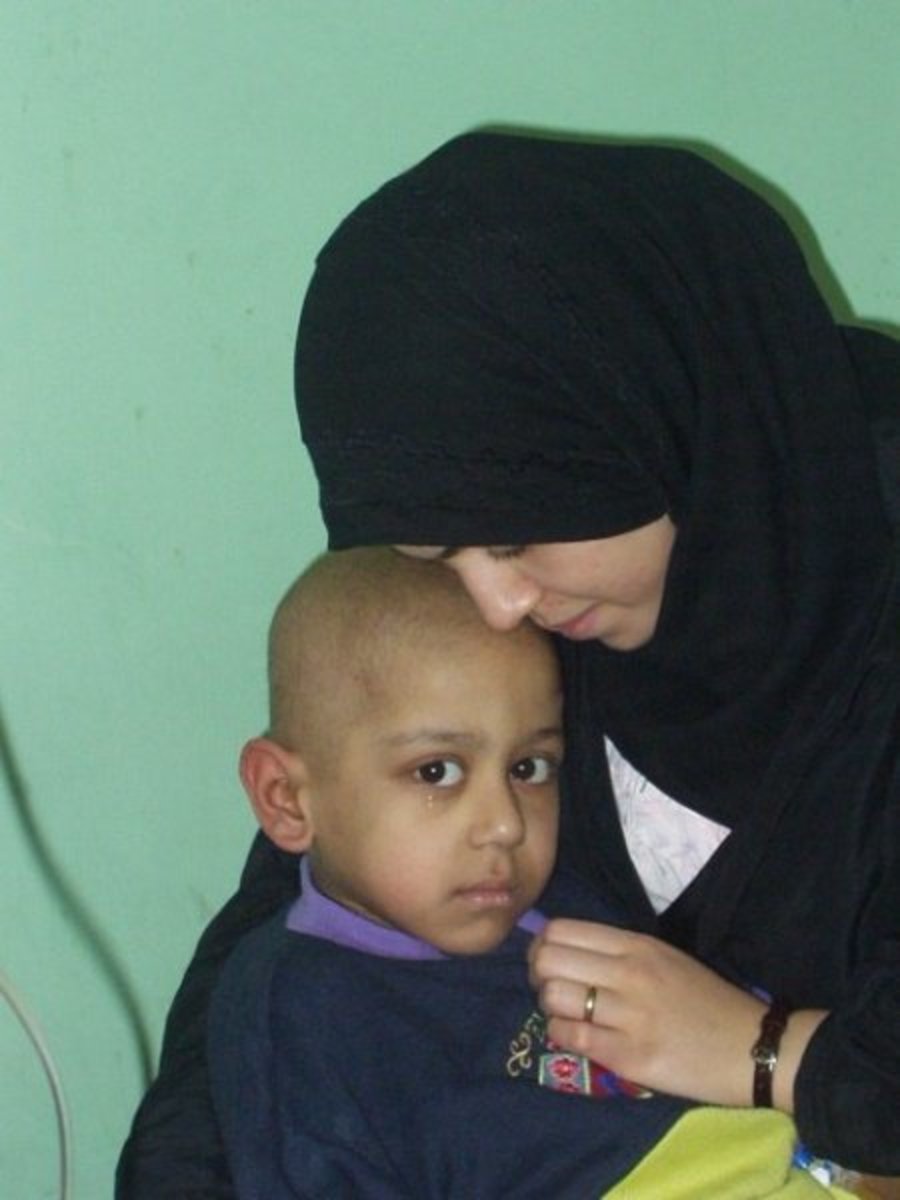Adra and her 5-year-old son Atarid in hospital. Atarid suffered from cancer. He died on the 3rd day of the United States Shock and Awe bombing.