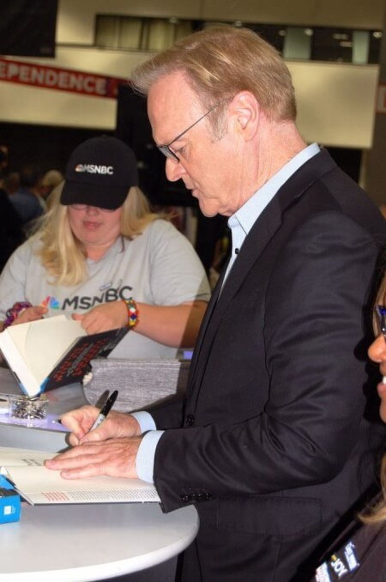  Cable TV host Lawrence O’Donnell autographs books at the MSNBC Booth in Democracy Village.