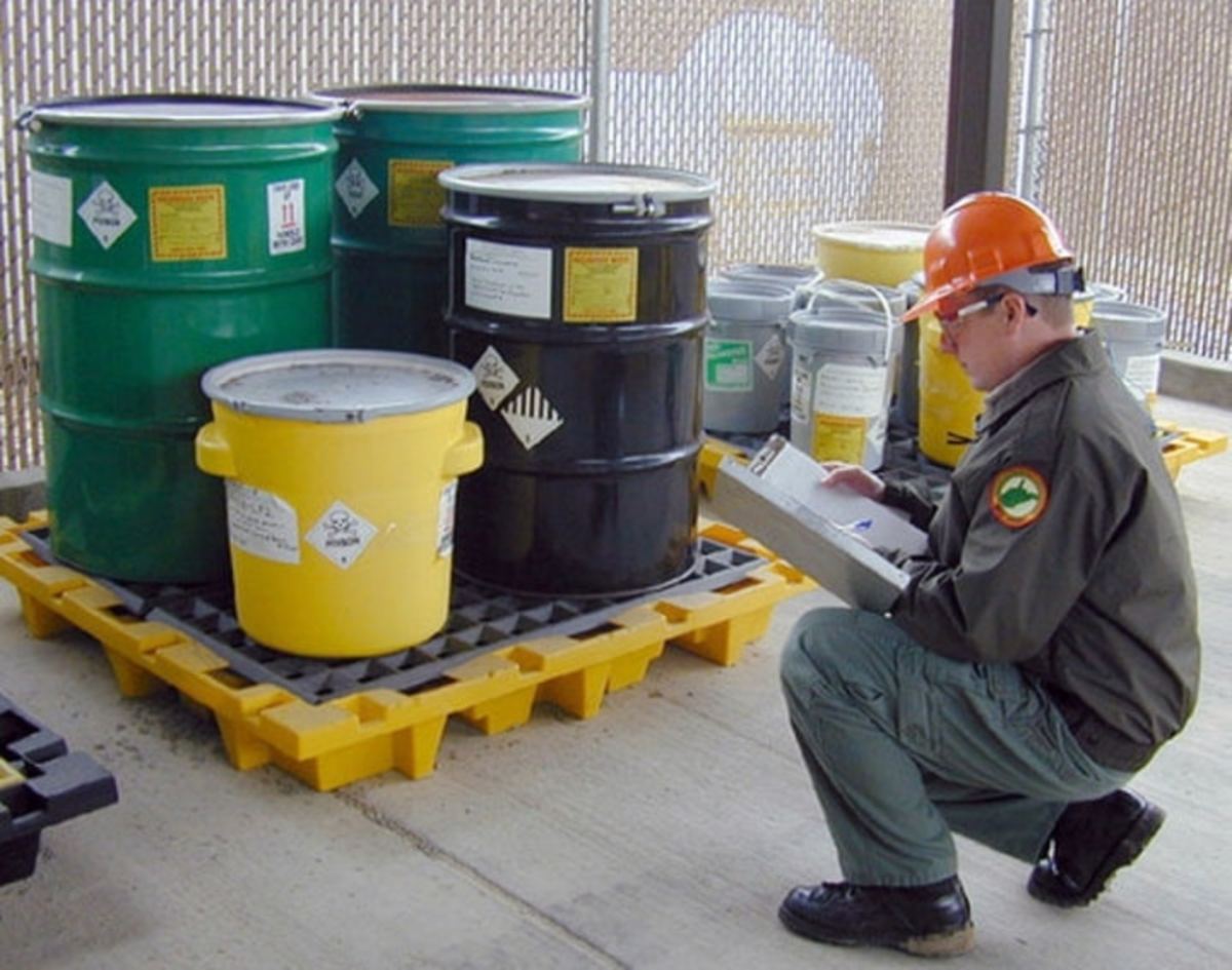 A Defense Logistics Agency contractor prepares for the removal of hazardous waste from a military installation.