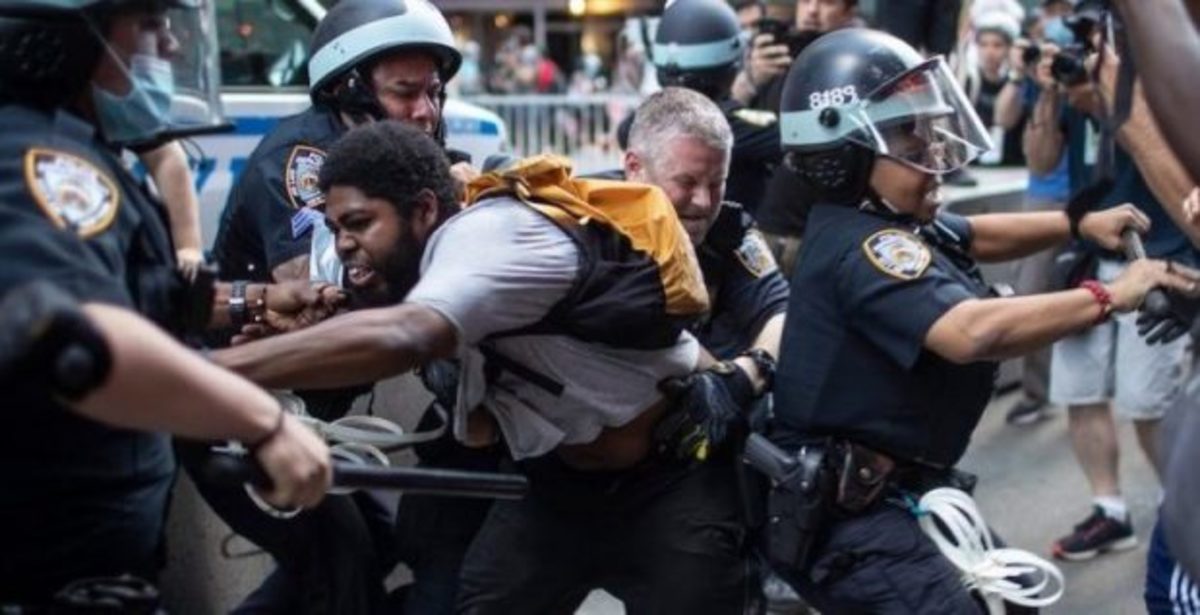  Police detain protesters as they march down the street during a solidarity rally for George Floyd, Saturday, May 30, 2020, in New York. AP Photo/Wong Maye-E.