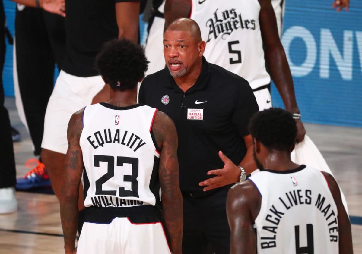 LAKE BUENA VISTA, FLORIDA - AUGUST 25: Head coach Doc Rivers of the LA Clippers talks with guard Lou Williams #23 in the first half against the Dallas Mavericks in game five of the first round of the 2020 NBA Playoffs at ESPN Wide World Of Sports Complex on August 25, 2020 in Lake Buena Vista, Florida. NOTE TO USER: User expressly acknowledges and agrees that, by downloading and or using this photograph, User is consenting to the terms and conditions of the Getty Images License Agreement. (Photo by Kim Klement-Pool/Getty Images)