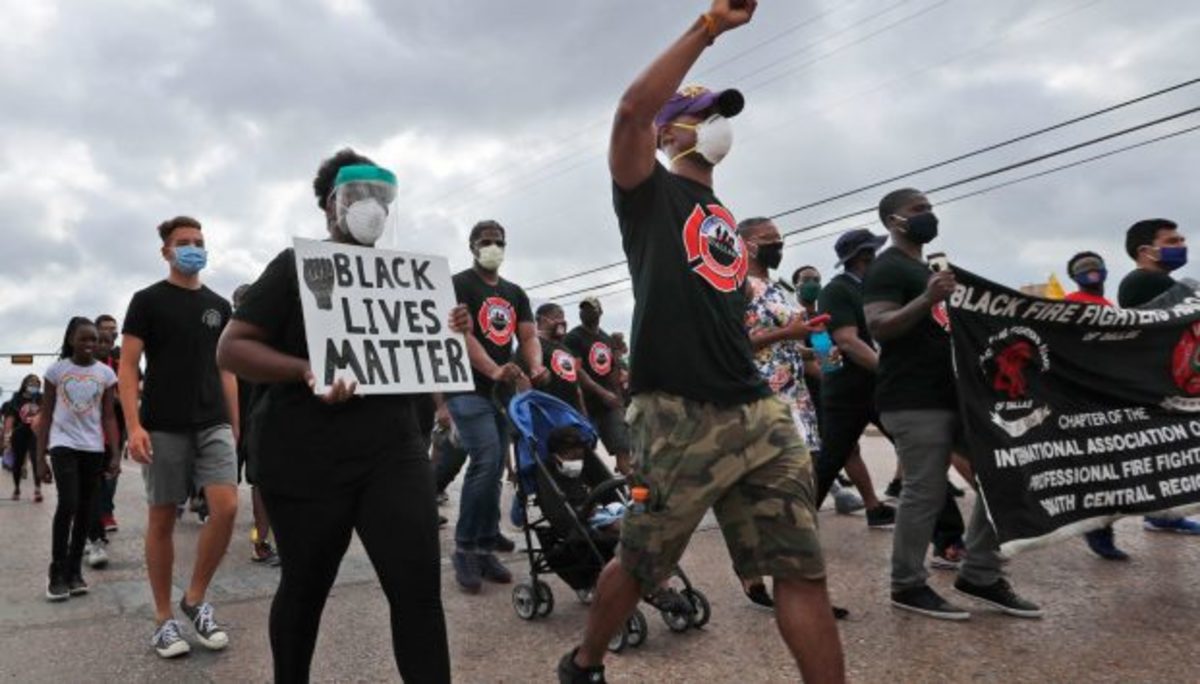  Protesters march in a Black Lives Matter demonstration organized by the Dallas Black Firefighters Association on Juneteenth 2020 in Dallas. AP Photo/LM Otero.