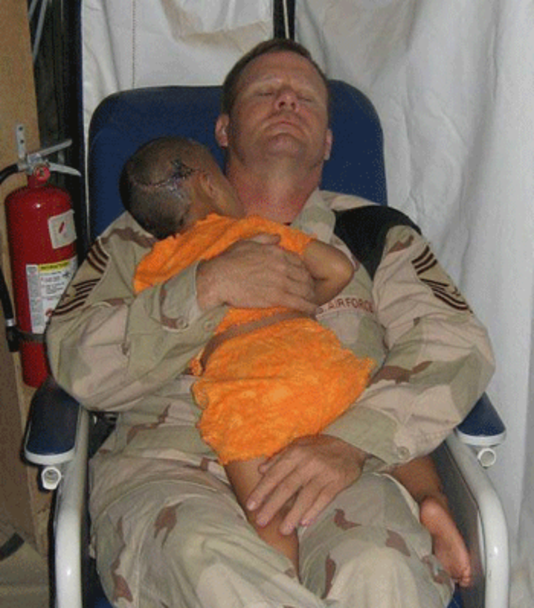 American airman John Gebhardt with Iraqi child.