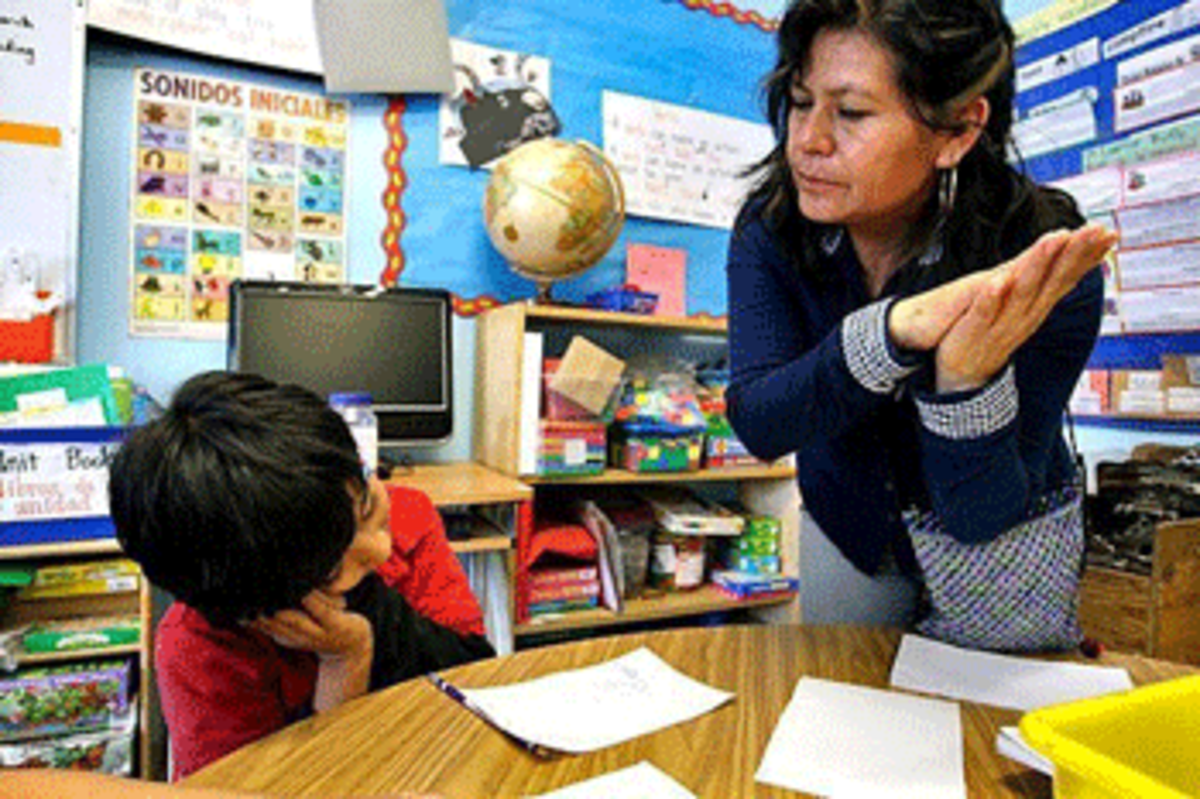 Juana de la Cruz Farias, a teacher at Academia Semillas del Pueblo, teaches Nahuatl, an indigenous language of Mexico, to Anthony Rayo. The Los Angeles Board of Education recently renewed the school's charter despite underperformance on state tests.