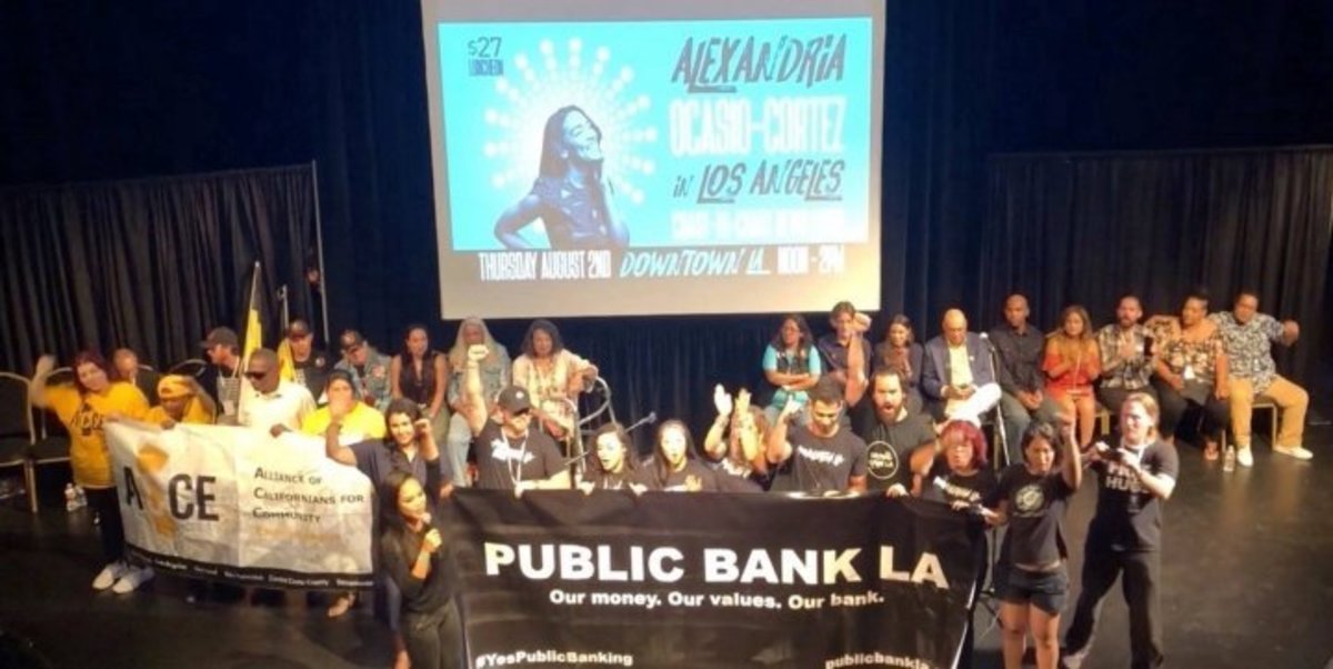 Activists rally for public banking at a rally featuring Alexandria Ocasio-Cortez