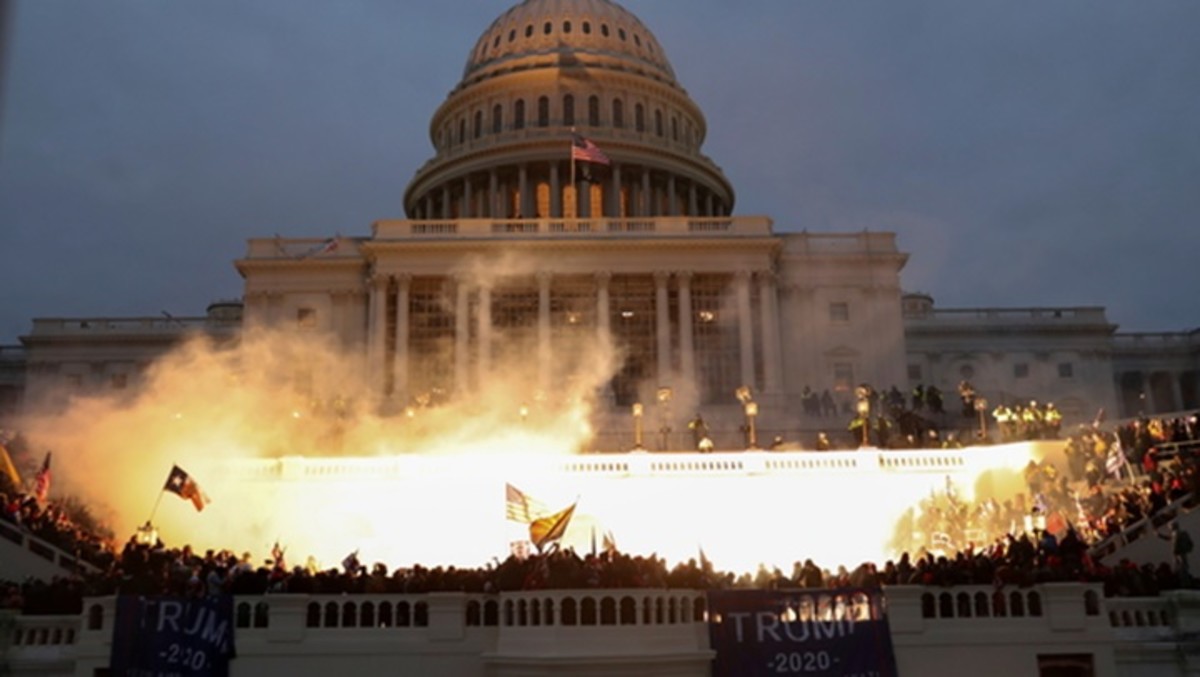 An explosion caused by a police munition is seen while supporters of U.S. President Donald Trump gather in front of the U.S. Capitol Building in Washington, U.S., January 6, 2021. REUTERS/Leah Millis     TPX IMAGES OF THE DAY - RC2M2L9E1RR3
