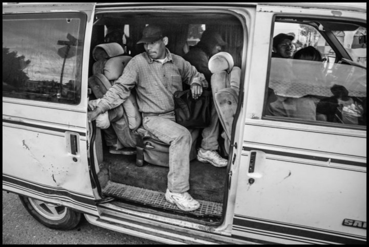 Workers get into a crowded van to go to the fields in Oxnard.