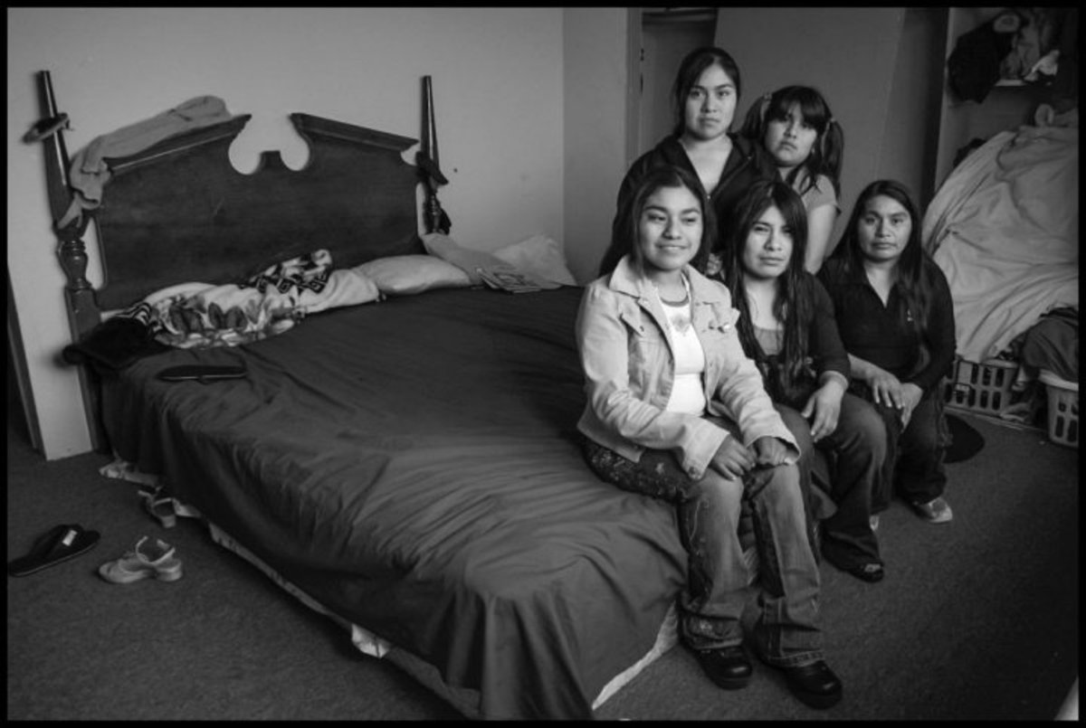 Guiillermina Ortiz Diaz, Graciela, Eliadora, Ana Lilia and their mother Bernardina Diaz Martinez sleep and live in a single room in a house in Oxnard, where three other migrant families also live.