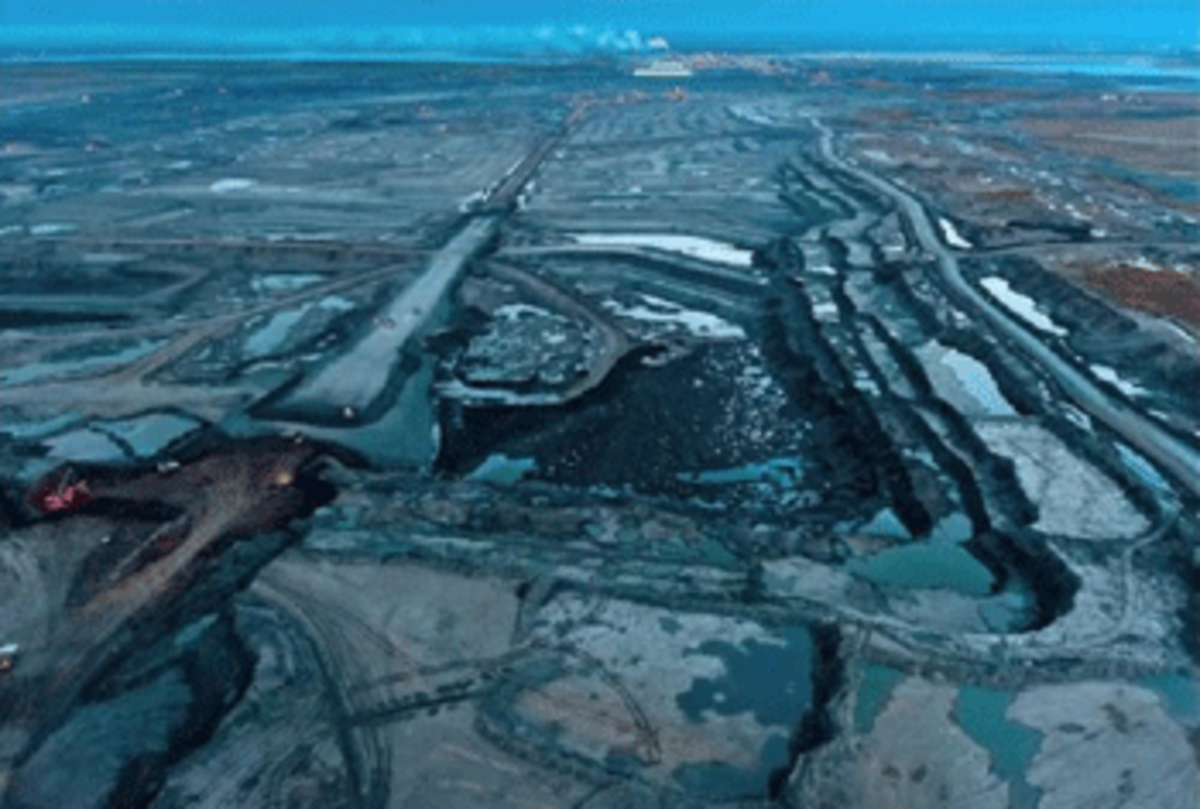 The Athabascan Tar Sands of Alberta, Canada. These deposits of sand saturated with bitumen, contain twice the amount of carbon dioxide emitted by global oil use in our entire history. Photography By Garth Lenz