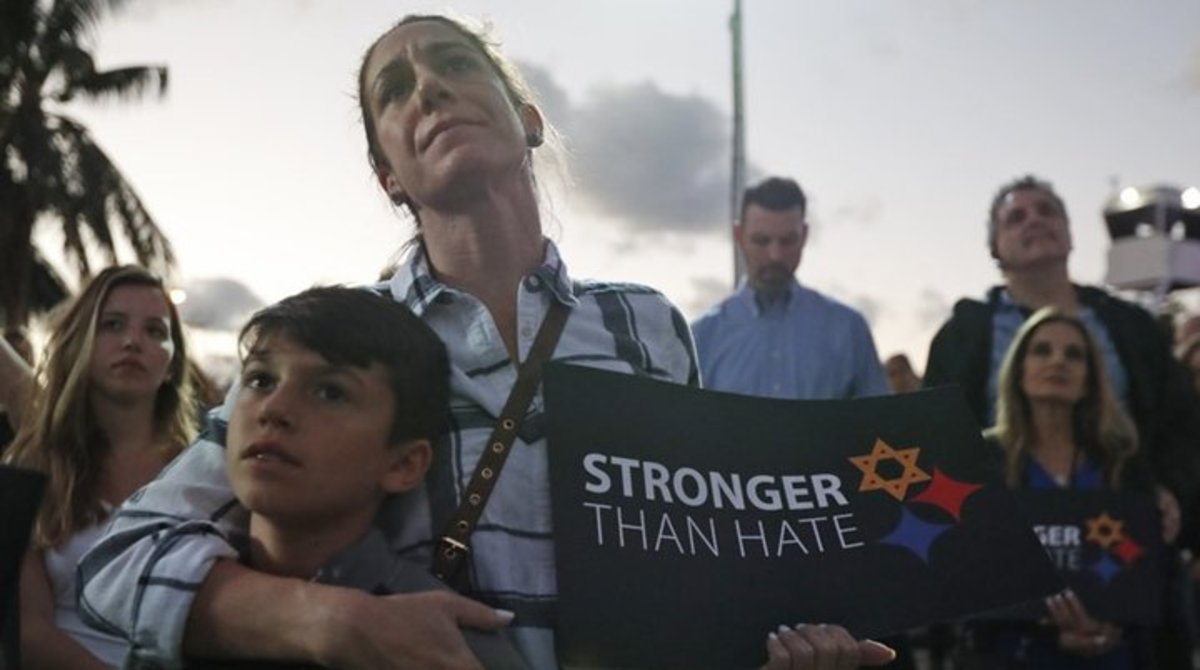 Taly Kogon and her son Leo, 10, listen to speakers during an interfaith vigil against anti-Semitism and hate at the Holocaust Memorial late last month in Miami Beach, FL Wilfredo Lee/AP