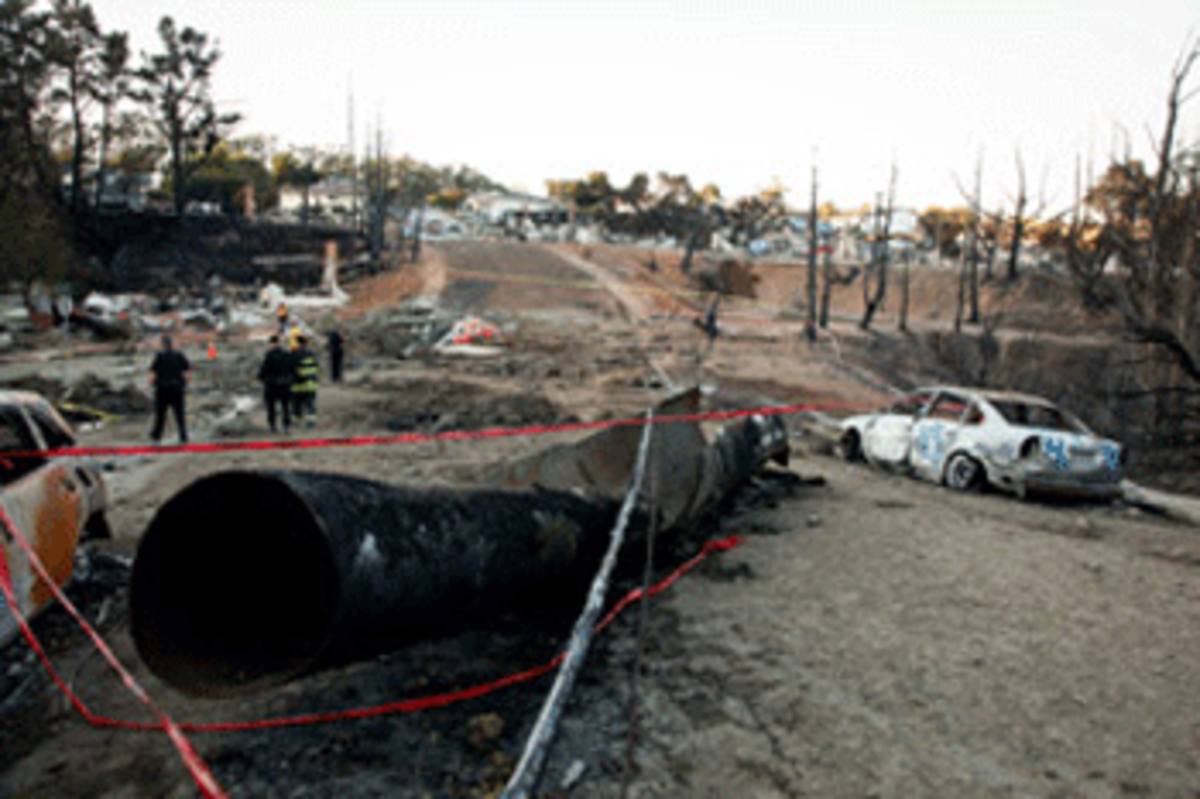The remains of a gas line lie on the ground after an explosion September 10, 2010 in San Bruno, California. (Photo by Eric Risberg-Pool/Getty Images)