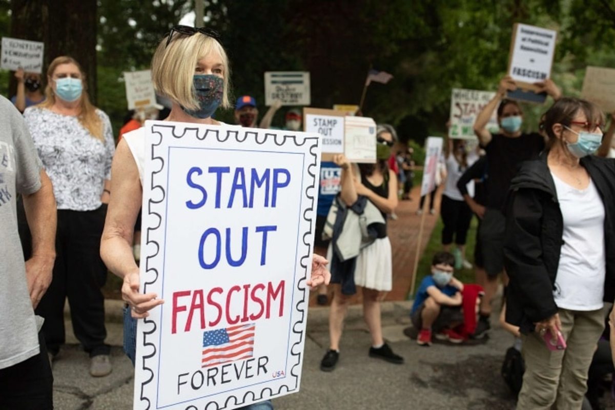 A group of protestors hold a demonstration in front of Postmaster General Louis DeJoy's home in Greensboro, North Carolina, on August 16, 2020. LOGAN CYRUS / AFP VIA GETTY IMAGES