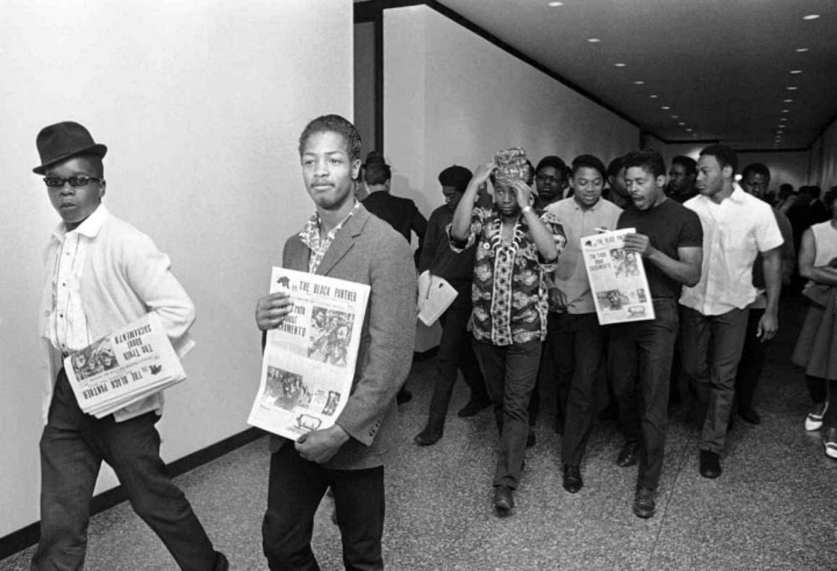 Several members of the Black Panther party carry copies of the Black Panther newspaper. Credit: Associated Press