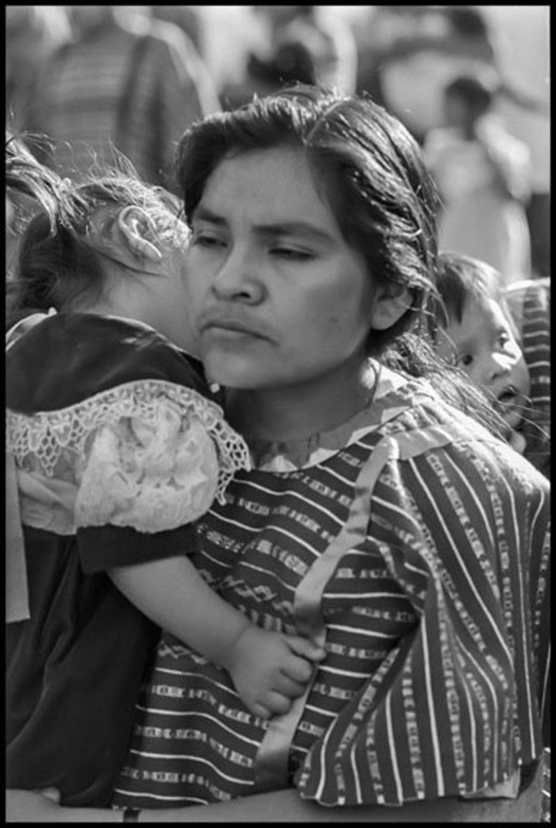 A Triqui marcher holds her infant son.