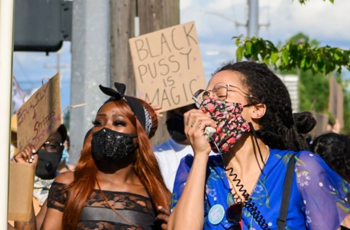 Coacoa Green (left) and Cat Hollis at a protest on June 24, 2020. Green walked a mile in 8" red platform heels, inspiring many at the protests to wear their work heels.