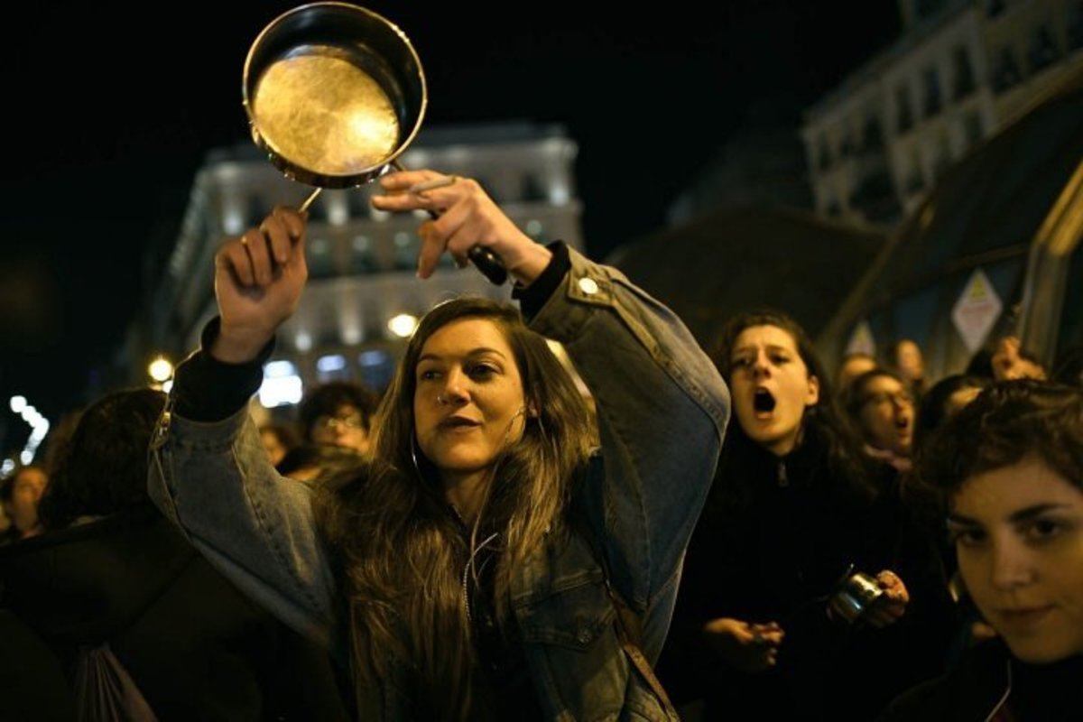 Spanish women bang pots and pans, shouting angry slogans during the 'cacerolada' (a pot-banging protest) at the Sol Square in Madrid. JUAN CARLOS LUCAS/NURPHOTO/GETTY