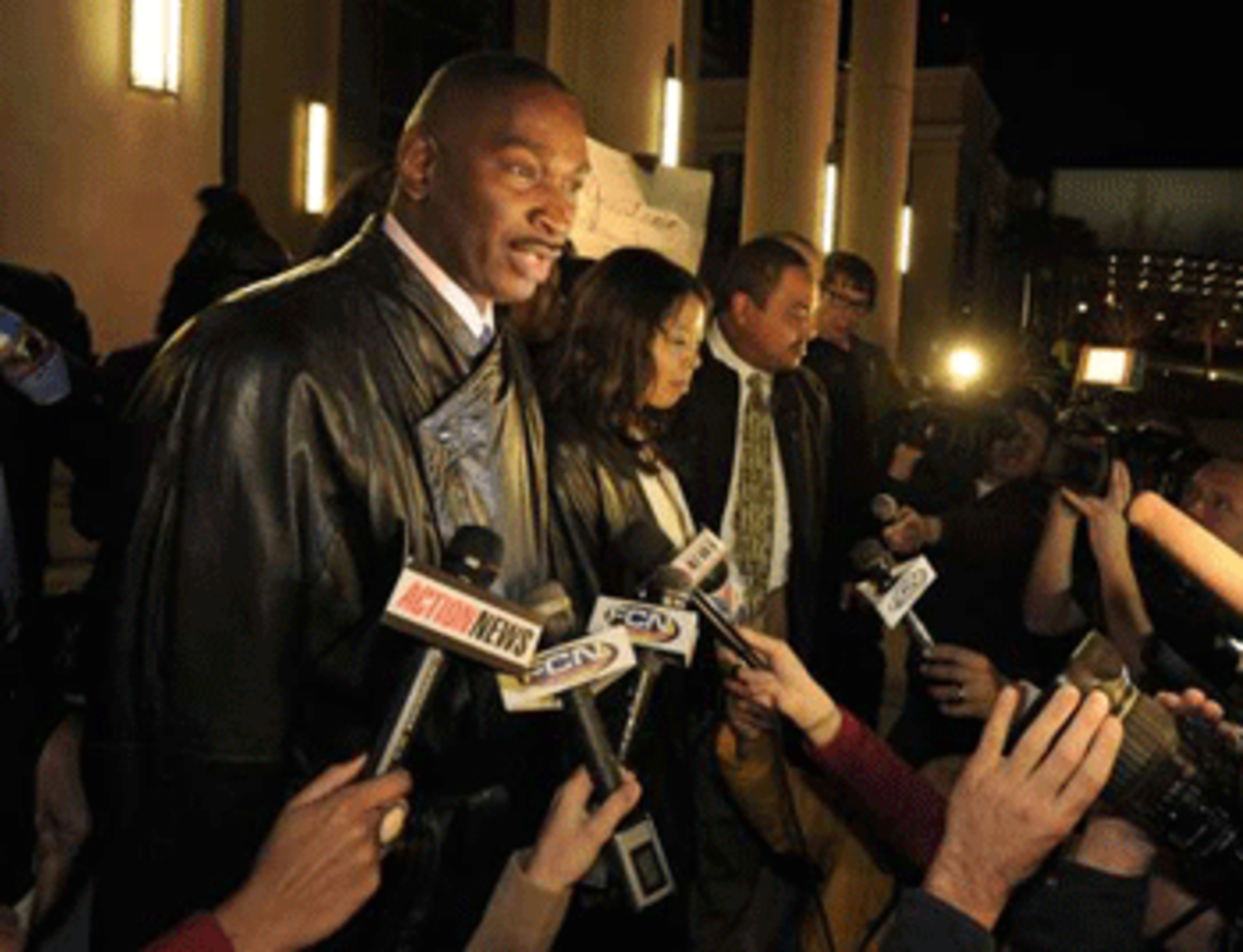 Ron Davis, the father of Jordan Davis, with Lucia McBath, Jordan's mother, talk to the media as he and other family members leave the Duval County Courthouse. (Bob Self/The Times-Union)