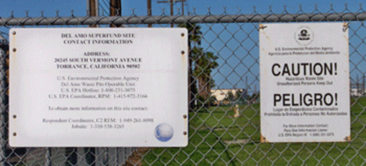 Caution signs on the fence at the Del Amo Superfund site near Torrance.