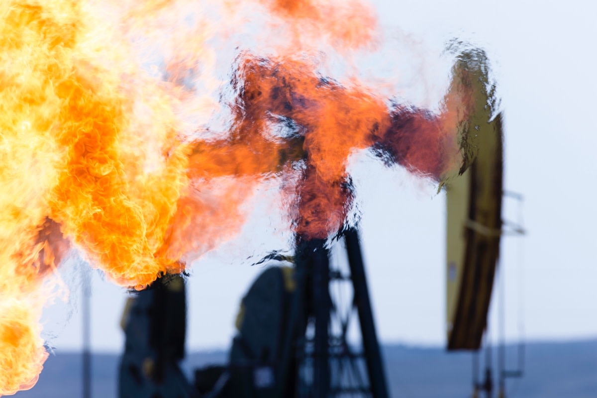 Methane gas flare and pump jack at an oil well in the Bakken Oil Fields, Mountrail County, North Dakota