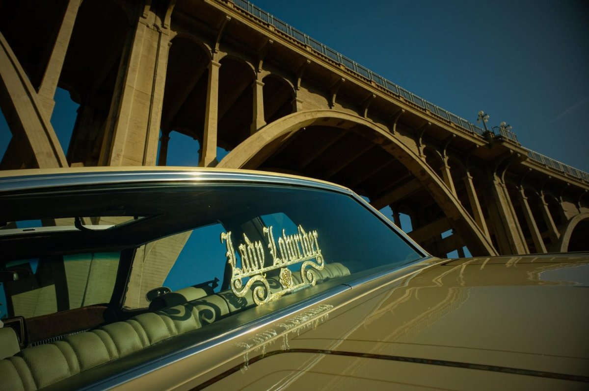 Sandy Avila’s ‘84 Cutlass parked under The Colorado Street Bridge, a historic landmark in Pasadena, California. Photo by Zaydee Sanchez for palabra