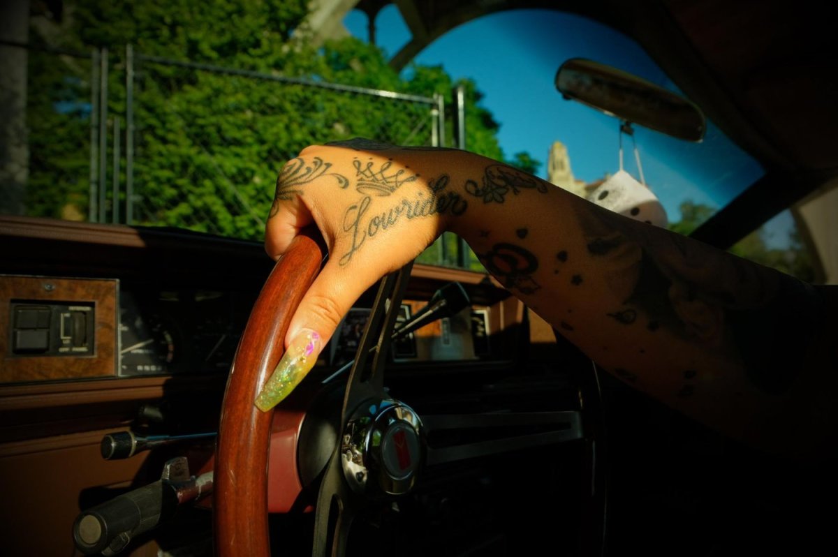 One of Sandy Avila’s many tattoos reading, Lowrider. Photo by Zaydee Sanchez for palabra.