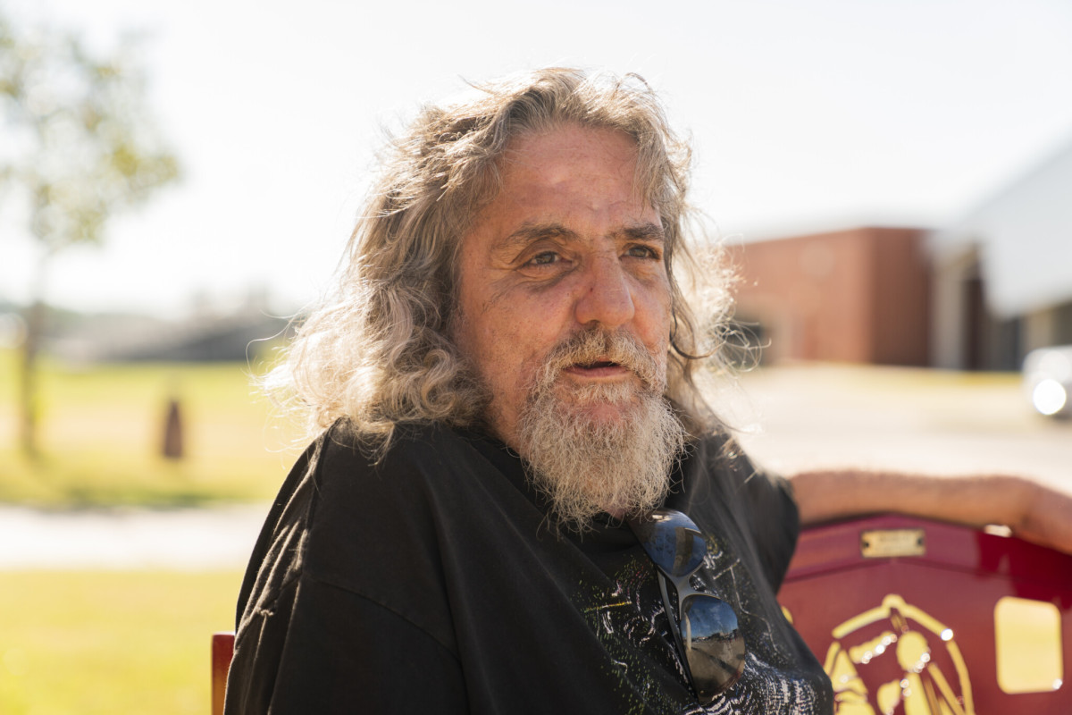 Bruce Charles Lachniet sits on a bench outside Riverside Indian School during the Road to Healing event. Nick Oxford for The Imprint