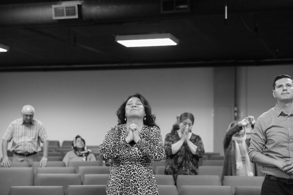 As Debbie preaches to the congregation, Leonor closes her eyes in prayer. Throughout Hugo’s detention Leonor says her faith has kept her going. July 10, 2022. Photo by Zaydee Sanchez for palabra