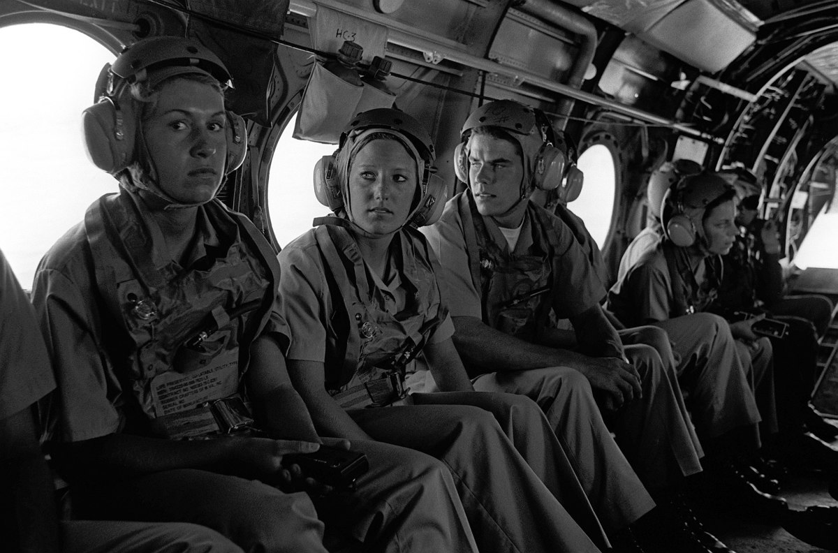 A group of midshipmen enrolled in the Naval Reserve Officers Training Corps (NROTC) wait to take off for a demonstration flight in a CH-46 Sea King helicopter.