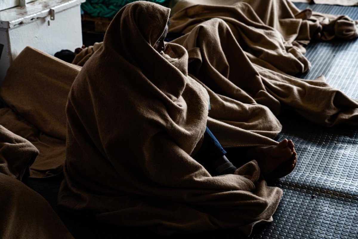 A survivor waits on the deck of the Geo Barents search-and-rescue ship in the Mediterranean Sea to be transported to a port of safety in Europe. April 28, 2022. Photo by Lexie Harrison-Cripps for palabra