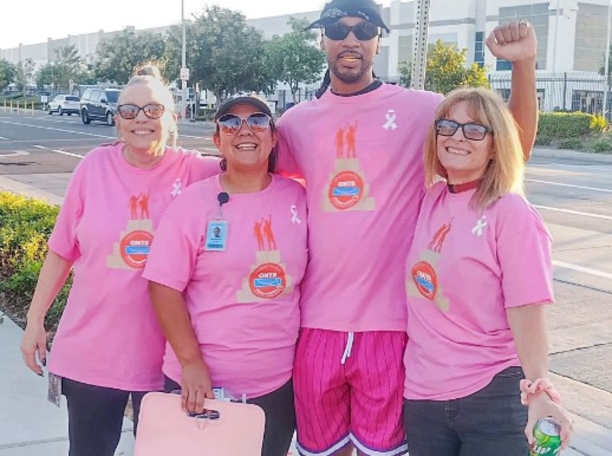 From left: Anji Morrison, Nannette Plascencia, Chris Smalls, and, Veronica Kern on October 19, 2022, during pro-union rally outside Amazon’s fulfillment center in Moreno Valley, California. The women are ONT8 workers. Smalls is the ALU president in Staten Island, New York. The workers are sporting pink because of breast cancer awareness month. (Photo: United4Change)