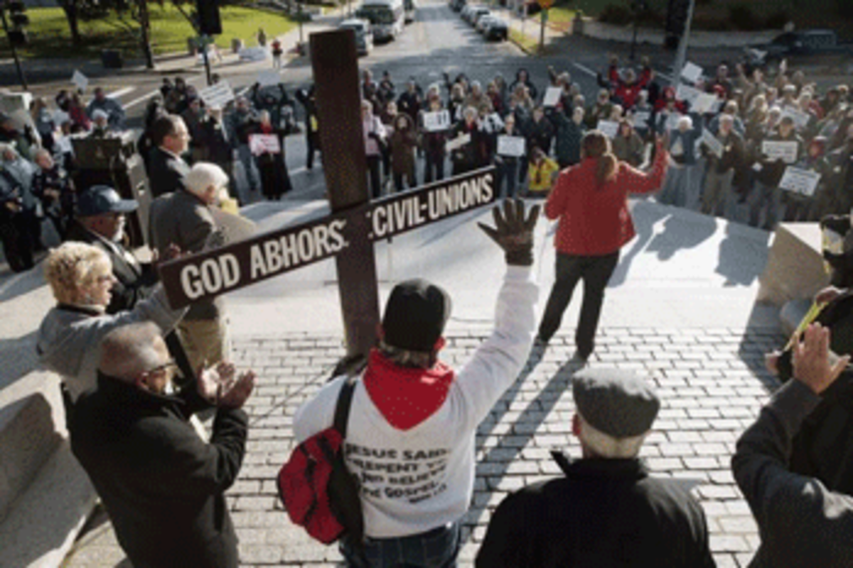 Pastor Joe Keller, of Kanakee, Ill., holds a giant cross as Linda Jernigan, of Chicago, speaks to the crowd as opponents of gay marriage gathered for the "Defend Marriage Lobby Day." (TED SCHURTER/AP)